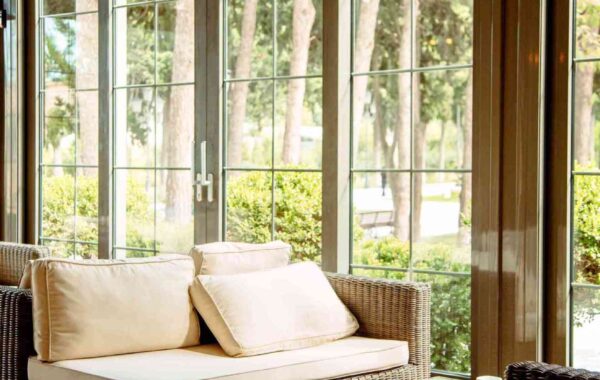 outdoor sofa with beige cushions coffee table front restaurant window