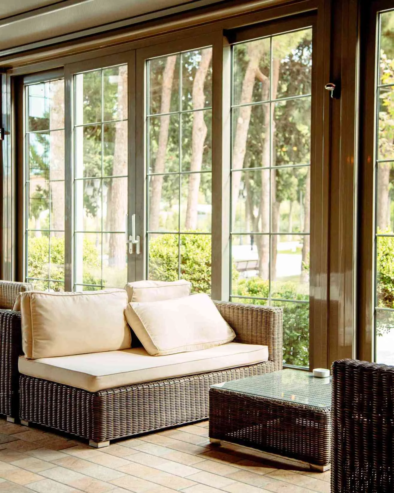 outdoor sofa with beige cushions coffee table front restaurant window